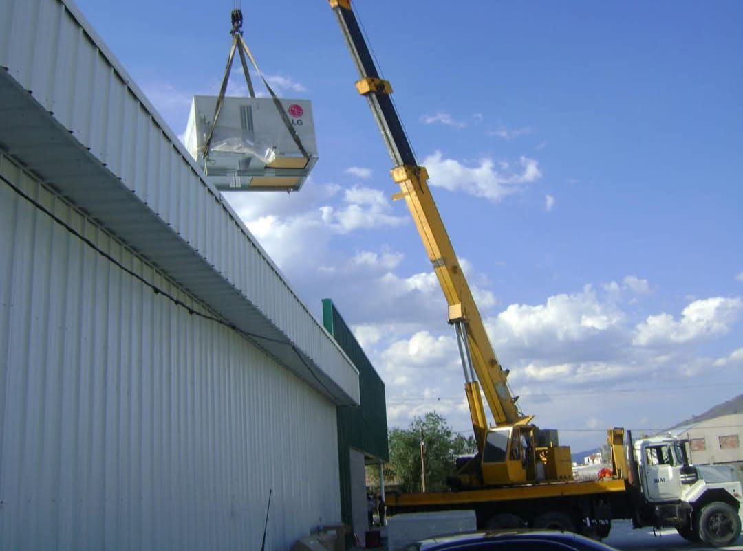 Crane installing HVAC equipment